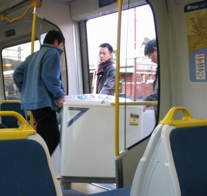 [On the train - two blokes and a washing machine]