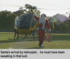 [Santa's arrival by helicopter... he must have been sweating in that suit]