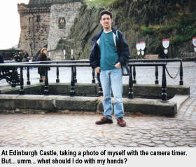 At Edinburgh Castle, taking a photo of myself with the camera timer. But... umm... what should I do with my hands?