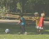 [The kids get down to the serious business of playing soccer]