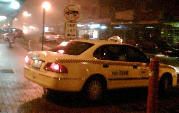 Taxi going the wrong way down a one way street