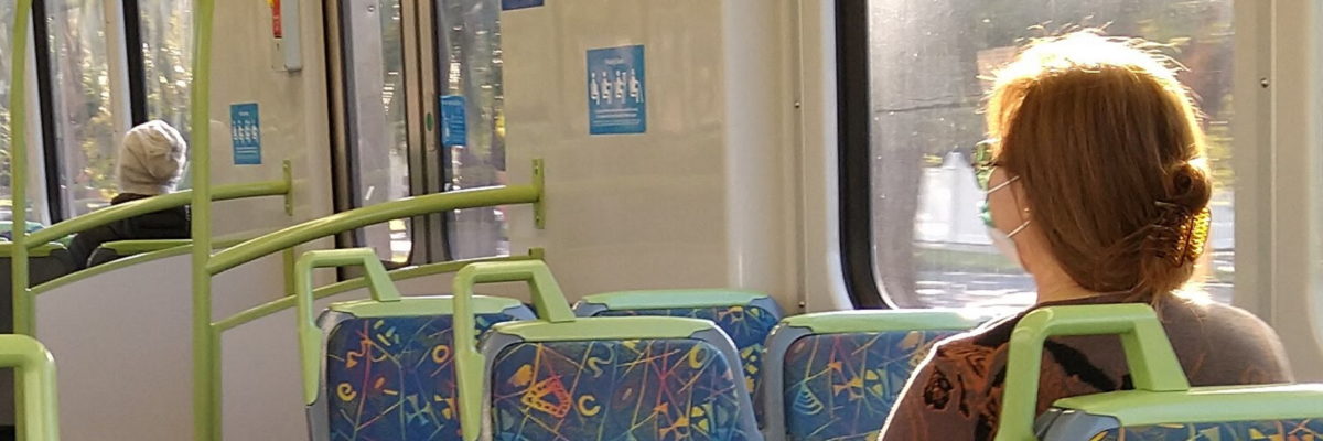 Train carriage; passenger wearing mask